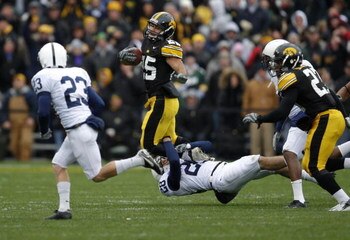 IOWA CITY, IA - NOVEMBER 8: Runningback Paki O'Meara #25 of the Iowa Hawkeyes is tackled by defenders Drew Astorino #28 of the Penn State Nittany Lions as teammate Kevin Kelly #23 and Jewel Hampton #27 of the Iowa Hawkeyes look on in the first quarter of 