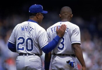 16 Apr 2000: Frank White #20 of the Kansas City Royals gives a pat on the back to Carlos Febles #3 during the game against the New York Yankees at Yankee Stadium in Bronx, New York. The Yankees defeated the Royals 8-4. Mandatory Credit: David Leeds  /Alls
