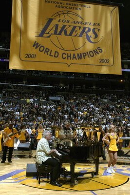 LOS ANGELES - OCTOBER 29:  Performer Randy Newman sings during the banner raising ceremony before the NBA season opener between the San Antonio Spurs and the Los Angeles Lakers at Staples Center on October 29, 2002 in Los Angeles, California.  The Spurs w