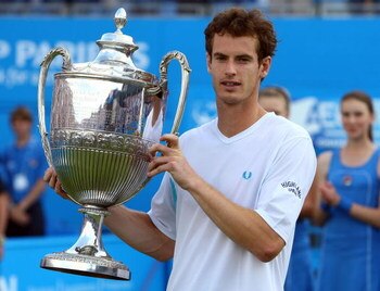 LONDON, ENGLAND - JUNE 14:  Andy Murray of Great Britain celebrates winning the match and the Championship with the trophy during the men's final match against James Blake of USA on Day 7 of the AEGON Championship at Queens Club on June 14, 2009 in London