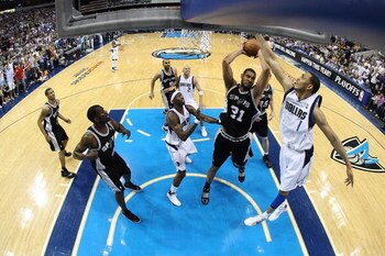 DALLAS - APRIL 25:  Forward Tim Duncan #21 of the San Antonio Spurs takes a shot against Ryan Hollins #1 of the Dallas Mavericks in Game Four of the Western Conference Quarterfinals during the 2009 NBA Playoffs at American Airlines Center on April 25, 200