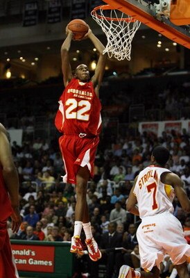 CORAL GABLES, FL - APRIL 01:  John Henson #22 of the West Team dunks over Dexter Strickland #7 of the East Team in the 2009 McDonald's All American Men's High School Basketball Game at BankUnited Center on April 1, 2009 in Coral Gables, Florida.  (Photo b