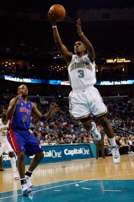 NEW ORLEANS - DECEMBER 05:  Chris Paul #3 of the New Orleans Hornets makes a shot around Jarvis Hayes #9 of the Detroit Pistons on December 5, 2007 at the New Orleans Arena in New Orleans, Louisiana.  NOTE TO USER: User expressly acknowledges and agrees t