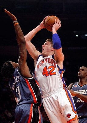 NEW YORK - MARCH 07:  David Lee #42 of the New York Knicks shoots the ball over Gerald Wallace #3 of the Charlotte Bobcats on March 7, 2009 at Madison Square Garden in New York City. NOTE TO USER: User expressly acknowledges and agrees that, by downloadin