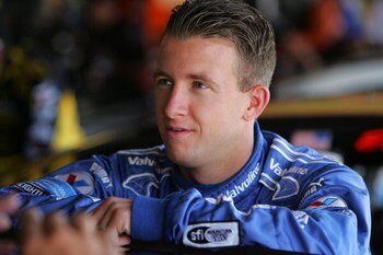 DOVER, DE - MAY 30:  AJ Allmendinger, driver of the #44 Auto Value Bumper Dodge, stands in the garage during practice for the NASCAR Sprint Cup Series Autism Speaks 400 at Dover International Speedway on May 30, 2009 in Dover, Delaware.  (Photo by Chris T