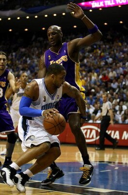ORLANDO, FL - JUNE 14:  Jameer Nelson #14 of the Orlando Magic drives the ball around Lamar Odom #7 of the Los Angeles Lakers in Game Five of the 2009 NBA Finals on June 14, 2009 at Amway Arena in Orlando, Florida.  NOTE TO USER:  User expressly acknowled