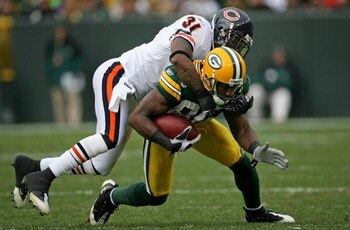 GREEN BAY, WI - NOVEMBER 16:  Wide receiver Greg Jennings #85 of the Green Bay Packers makes a reception for nine yards and is tackled by Nathan Vasher #31 of the Chicago Bears during NFL action at Lambeau Field on November 16, 2008 in Green Bay, Wisconsi