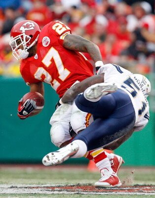 KANSAS CITY, MO - DECEMBER 14:  Larry Johnson #27 of the Kansas City Chiefs is tackled by Tim Dobbins #51 of the San Diego Chargers during the first half on December 14, 2008 at Arrowhead Stadium in Kansas City, Missouri. The Chiefs lost 22-21.  (Photo by