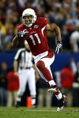 TAMPA, FL - FEBRUARY 01:  Wide receiver Larry Fitzgerald #11 of the Arizona Cardinals scores a 64-yard touchdown reception in the fourth quarter against the Pittsburgh Steelers during Super Bowl XLIII on February 1, 2009 at Raymond James Stadium in Tampa,