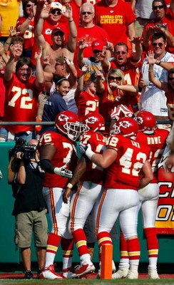 KANSAS CITY, MO - SEPTEMBER 28:  Fans cheer as teammates congratulate Larry Johnson #27 of the Kansas City Chiefs after Johnson rushed for a touchdown during the fourth quarter of the game against the Denver Broncos on September 28, 2008 at Arrowhead Stad