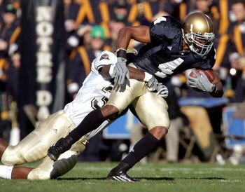 SOUTH BEND, IN - NOVEMBER 13:  Running back Ryan Grant #4 of Notre Dame tries to break away from linebacker Derron Thomas #39 of Pittsburgh on November 13, 2004 at Notre Dame Stadium in South Bend, Indiana.  (Photo by Jonathan Daniel/Getty Images)