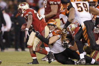 SAN FRANCISCO - DECEMBER 15:  Running back Frank Gore #21 of the San Francisco 49ers drags defensive lineman Domata Peko #94 of the Cincinnati Bengals behind him as Gore ran for 138 yards during a game at Monster Park December 15, 2007 in San Francisco, C