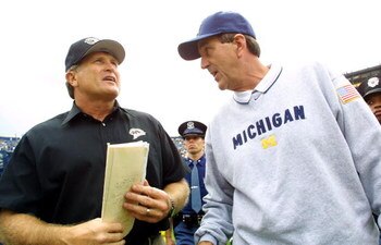 22 Sep 2001:  Michigan Head Coach Lloyd Carr, wearing an American Flag Patch, greets Western Michigan Head Coach Gary Darnell after the Wolverine's Victory over the Broncos at Michigan Stadium (The Big House) in Ann Arbor, Michigan. Michigan beat Western 