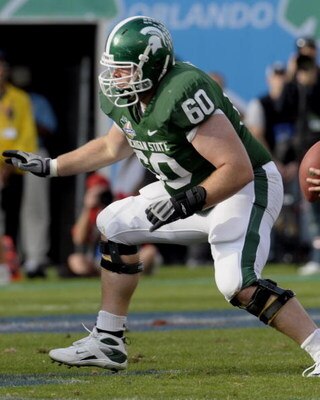 ORLANDO, FL - JANUARY 1: Offensive lineman Mike Bacon #60 of the Michigan State Spartans sets to block against the Georgia Bulldogs at the 2009 Capital One Bowl at the Citrus Bowl on January 1, 2009 in Orlando, Florida.  (Photo by Al Messerschmidt/Getty I