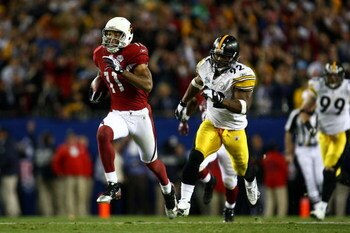 TAMPA, FL - FEBRUARY 01:  Wide receiver Larry Fitzgerald #11 of the Arizona Cardinals scores a 64-yard touchdown reception in the fourth quarter against James Harrison #92 of the Pittsburgh Steelers during Super Bowl XLIII on February 1, 2009 at Raymond J