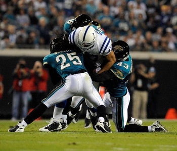 JACKSONVILLE, FL - DECEMBER 18:  Gijon Robinson #47 of the Indianapolis Colts is tackled by Reggie Nelson #25 and Gerald Sensabaugh #43 of the Jacksonville Jaguars during the game at Jacksonville Municipal Stadium on December 18, 2008 in Jacksonville, Flo
