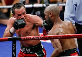 LAS VEGAS - SEPTEMBER 13:  Juan Manuel Marquez (L) hits Joel Casamayor in the 11th round of their bout at the MGM Grand Garden Arena September 13, 2008 in Las Vegas, Nevada. Marquez won by knockout in the 11th round.  (Photo by Ethan Miller/Getty Images)