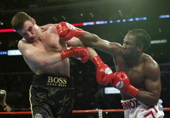 LOS ANGELES - JUNE 21:  Lennox Lewis (right) hits Vitali Klitschko (left) during their WBC and IBO World Heavyweight Championship bout at the Staples Center on June 21, 2003 in Los Angeles, California.  Lennox Lewis (41-2-1) defeated Vitali Klitschko (32-