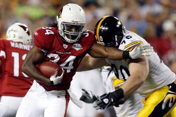 TAMPA, FL - FEBRUARY 01:  Running back Tim Hightower #34 of the Arizona Cardinals runs the ball and attempts to get by defensive end Travis Kirschke #90 of the Pittsburgh Steelers during Super Bowl XLIII on February 1, 2009 at Raymond James Stadium in Tam