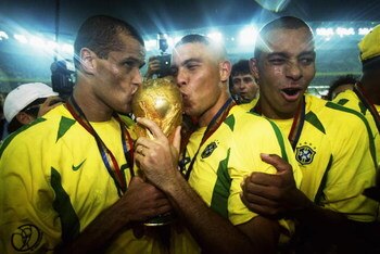 YOKOHAMA - JUNE 30:  Rivaldo and Ronaldo of Brazil kiss the trophy after the Germany v Brazil, World Cup Final match played at the International Stadium Yokohama in Yokohama, Japan on June 30, 2002. Brazil won 2-0. (Photo by Alex Livesey/Getty Images)