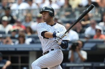 NEW YORK - JUNE 14:  Derek Jeter #2 of the New York Yankees hits an RBI single in the second inning against the New York Mets on June 14, 2009 at Yankee Stadium in the Bronx borough of New York City.  (Photo by Nick Laham/Getty Images)