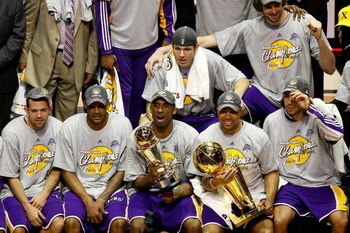 ORLANDO, FL - JUNE 14:  (L-R) Jordan Farmar #5, Trevor Ariza #3, Kobe Bryant #24, Luke Walton #4, Derek Fisher #2, Pau Gasol #16 and Sasha Vujacic #18 of the Los Angeles Lakers pose together after defeating the Orlando Magic in Game Five of the 2009 NBA F