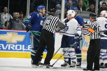 VANCOUVER - JANUARY 10:  Jarkko Ruutu #37 of the Vancouver Canucks and Tie Domi #28 of the Toronto Maple Leafs are seperated by the linesman during the NHL game on January 10, 2006 at General Motors Place in Vancouver, Canada. The Canucks defeated the Map