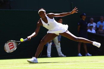 WIMBLEDON, ENGLAND - JUNE 23:  Venus Williams of USA stretches to play a forehand during the women's singles first round match against Stefanie Voegele of Switzerland on Day Two of the Wimbledon Lawn Tennis Championships at the All England Lawn Tennis and