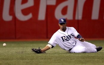 ST. PETERSBURG, FL - OCTOBER 10:  Carl Crawford #13 of the Tampa Bay Rays misses a catch on an RBI single hit by Kevin Youkilis #20 of the Boston Red Sox in the eighth inning of game one of the American League Championship Series during the 2008 MLB playo