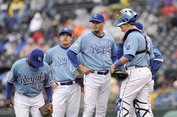 KANSAS CITY, MO - APRIL 12:  Pitcher Gil Meche #55 of the Kansas City Royals stands with teammates on the mound against the New York Yankees on April 12, 2009 at Kauffman Stadium in Kansas City, Missouri. (Photo by G. Newman Lowrance/Getty Images)
