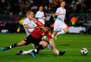 BLOEMFONTEIN, SOUTH AFRICA - JUNE 24:  Jay DeMerit of USA tackles David Villa of Spain during the FIFA Confederations Cup Semi Final match between Spain and USA at Free State Stadium on June 24, 2009 in Bloemfontein, South Africa.  (Photo by Jamie McDonal