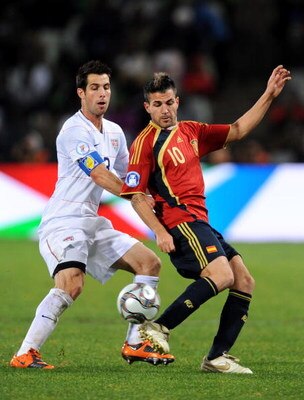 BLOEMFONTEIN, SOUTH AFRICA - JUNE 24:  Cesc Fabregas of Spain (R) duels for the ball with Carlos Bocanegra of USA during the FIFA Confederations Cup Semi Final match between Spain and USA at Free State Stadium on June 24, 2009 in Bloemfontein, South Afric