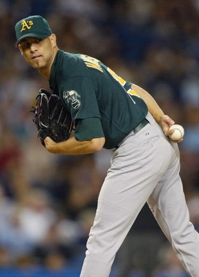 BRONX, NY - APRIL 27:  Tim Hudson #15 of the Oakland A's holds the runner with a look to first base during the game against the New York Yankees on April 27, 2004 at Yankee Stadium in the Bronx, New York.  The Yankees defeated the Athletics 10-8.  (Photo 