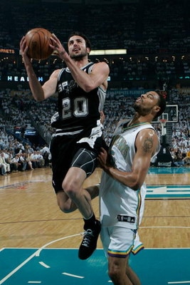 NEW ORLEANS - MAY 19:  Manu Ginobili #20 of the San Antonio Spurs makes a shot over Tyson Chandler #16 of the New Orleans Hornets in Game Seven of the Western Conference Semifinals during the 2008 NBA Playoffs at The New Orleans Arena on May 19, 2008 in N