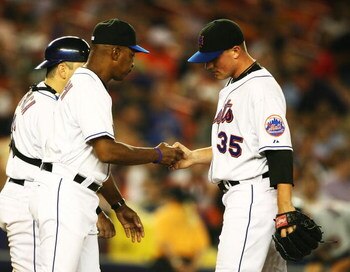 NEW YORK - SEPTEMBER 26: Joe Smith #35  of the New York Mets hands the ball to Manager Willie Randolph and leaves the game after giving up two runs in the fifth inning against the Washington Nationals during their game at Shea Stadium on September 26, 200