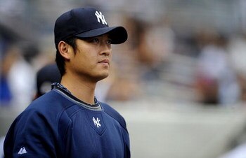 NEW YORK - JUNE 13:  Chien-Ming Wang #40 of the New York Yankees stands in the dugout in a game against the New York Mets on June 13, 2009 at Yankee Stadium in the Bronx Borough of New York City.  (Photo by Jeff Zelevansky/Getty Images)