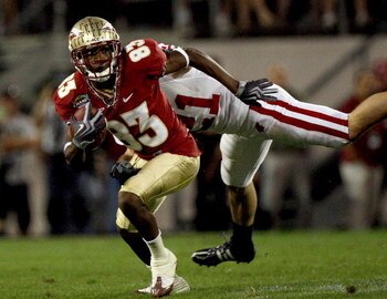 ORLANDO, FL - DECEMBER 27:  Bert Reed #83 of the Florida State Seminoles breaks the tackle of Chris Maragos #21 of the Wisconsin Badgers during the Champs Bowl on December 27, 2008 at the Citrus Bowl in Orlando, Florida.  (Photo by Sam Greenwood/Getty Ima