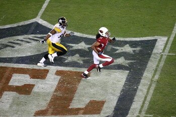 TAMPA, FL - FEBRUARY 01:  Larry Fitzgerald #11 of the Arizona Cardinals scores on a 64-yard touchdown reception in the fourth quarter against James Harrison #92 of the Pittsburgh Steelers during Super Bowl XLIII on February 1, 2009 at Raymond James Stadiu