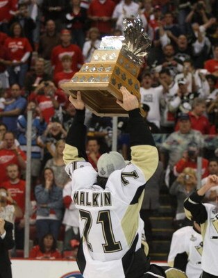 DETROIT - JUNE 12: Evgeni Malkin #71 of the Pittsburgh Penguins holds teh Conn Smythe trophy following the Penguins victory over the Detroit Red Wings in Game Seven of the 2009 NHL Stanley Cup Finals at Joe Louis Arena on June 12, 2009 in Detroit, Michiga