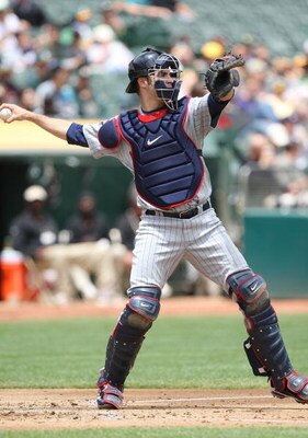 OAKLAND, CA - JUNE 11:  Joe Mauer #7 of the Minnesota Twins catches against the Oakland Athletics during a Major League Baseball game on June 11, 2009 at the Oakland Coliseum in Oakland, California.  (Photo by Jed Jacobsohn/Getty Images)