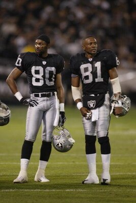 OAKLAND, CA - NOVEMBER 17:  Jerry Rice #80 and Tim Brown #81 of the Oakland Raiders stand on the field during the game against the New England Patriots on November 17, 2002 at Network Associates Coliseum in Oakland, California. The Raiders defeated the Pa