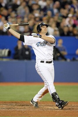 TORONTO - APRIL 6:  Adam Lind #26 of the Toronto Blue Jays swings at the pitch during the Opening Day game against the Detroit Tigers at the Rogers Centre on April 6, 2009 in Toronto, Ontario. (Photo by: Dave Sandford/Getty Images)
