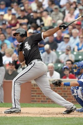 CHICAGO - JUNE 17: Jermaine Dye #23 of the Chicago White Sox makes a hit against the Chicago Cubs on June 17, 2009 at Wrigley Field in Chicago, Illinois. (Photo by Jonathan Daniel/Getty Images)
