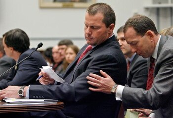 WASHINGTON - FEBRUARY 13: Major League Baseball pitcher Roger Clemens (L) gets a note from his attorney Lanny Breuer while he testifies about allegations of steroid use by professional ball palyers before the U.S. House Oversight and Government Reform Com