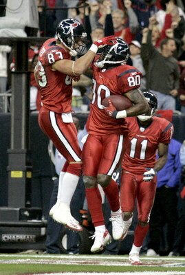 HOUSTON - DECEMBER 13:  Kevin Walter #83 celebrates a touchdown with Andre Johnson #80 of the Houston Texans during the NFL game against the Denver Broncos at  Reliant Stadium on December 13, 2007 in Houston, Texas. (Photo by Thomas B.  Shea/Getty Images)