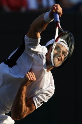 WIMBLEDON, ENGLAND - JUNE 26:  Tommy Haas of Germany serves during the men's singles third round match against Marin Cilic of Croatia on Day Five of the Wimbledon Lawn Tennis Championships at the All England Lawn Tennis and Croquet Club on June 26, 2009 i