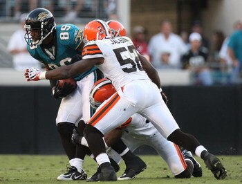 JACKSONVILLE, FL - OCTOBER 26:  Marcedes Lewis #89 of the Jacksonville Jaguars is tackled by Alex Hall #96 and D'Quell Jackson #52 of the Cleveland Browns after making a reception in a game at Jacksonville Muncipal Stadium on October 26, 2008 in Jacksonvi