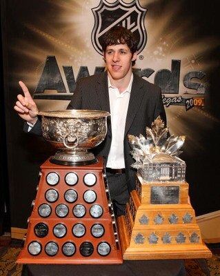 LAS VEGAS - JUNE 18:  Evgeni Malkin of the Pittsburgh Penguins poses with the Art Ross Trophy and the Conn Smythe Trophy following the 2009 NHL Awards at the Palms Casino Resort on June 18, 2009 in Las Vegas, Nevada.  (Photo by Bruce Bennett/Getty Images 