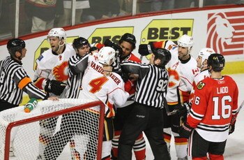 CHICAGO - APRIL 25: The linesmen try to seperate Dustin Byfuglien #33 of the Chicago Blackhawks and James Vandermmer #4 of the Calgary Flames during Game Five of the Western Conference Quarterfinals of the 2009 Stanley Cup Playoffs on April 25, 2009 at th