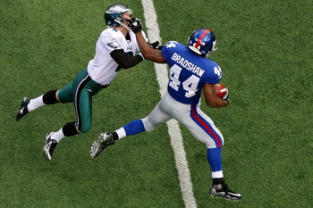 EAST RUTHERFORD, NJ - JANUARY 11:  Ahmad Bradshaw #44 of the New York Giants stiff arms kicker David Akers #2 of the Philadelphia Eagles on a return during the NFC Divisional Playoff Game on January 11, 2009 at Giants Stadium in East Rutherford, New Jerse
